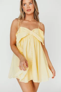 Discount Worth Collective Irelyn Babydoll Mini Dress with Bow Accent in Yellow