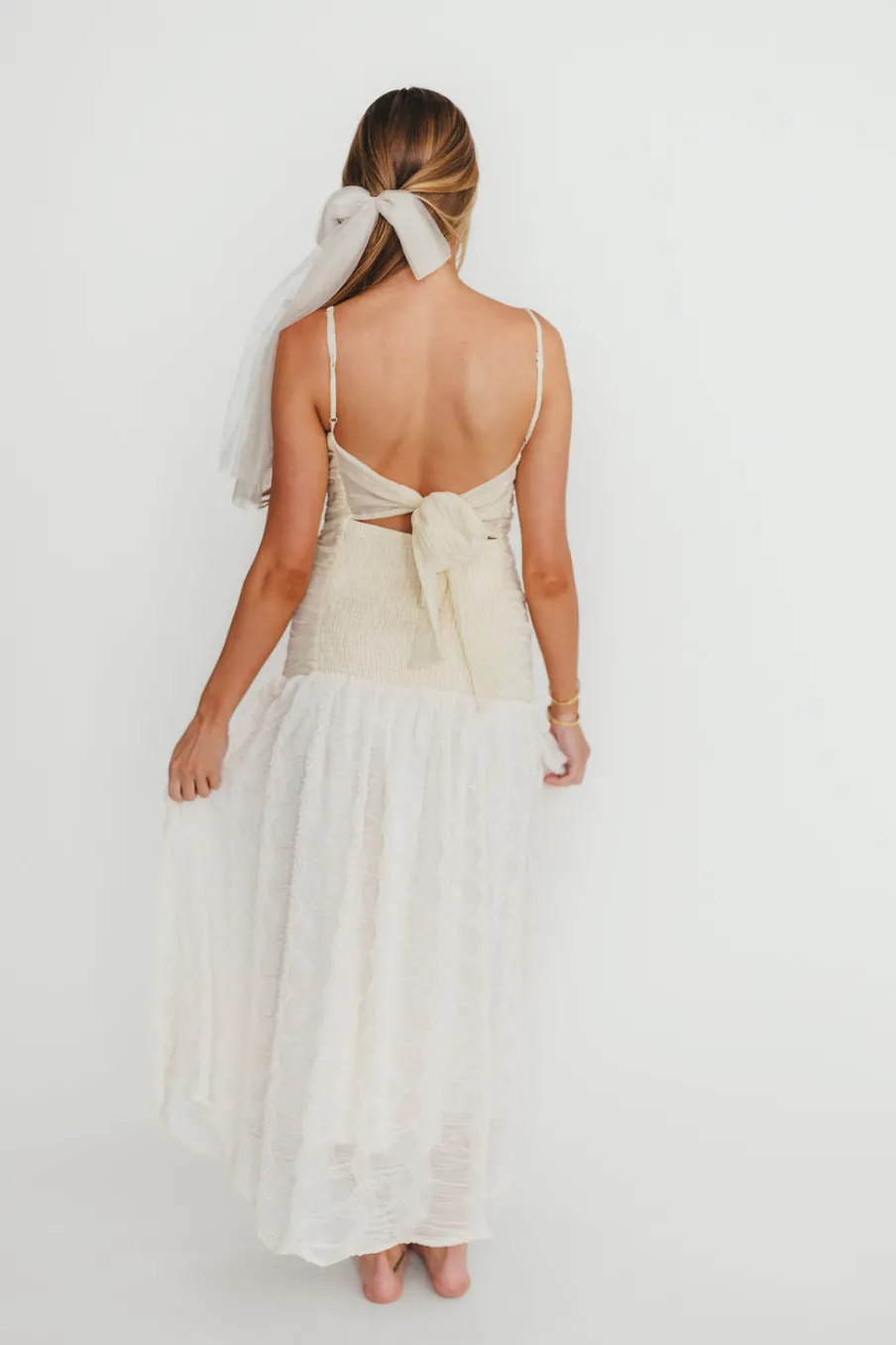 Fashion Worth Collective Rosie Ruched Maxi Dress With Bow Back Detail in Cream
